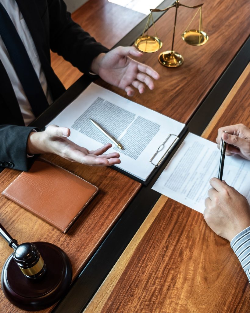 male-lawyer-discussing-negotiation-legal-case-with-client-meeting-with-document-contract-in-office.jpg